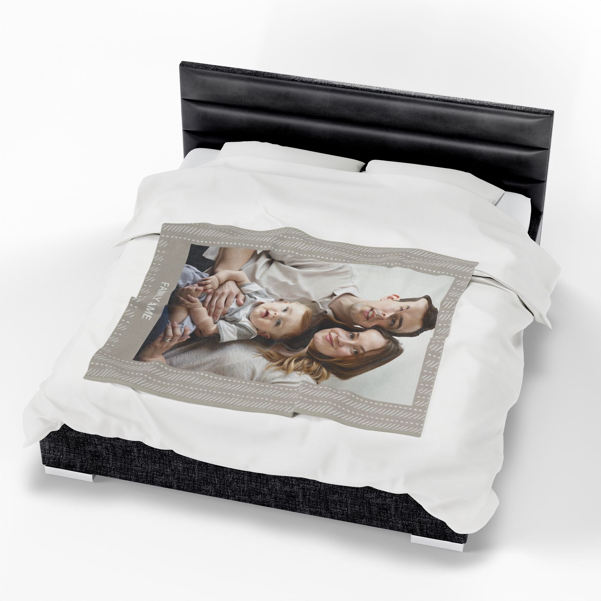 Custom photo blanket with a printed family picture and personalized name, displayed on a bed

