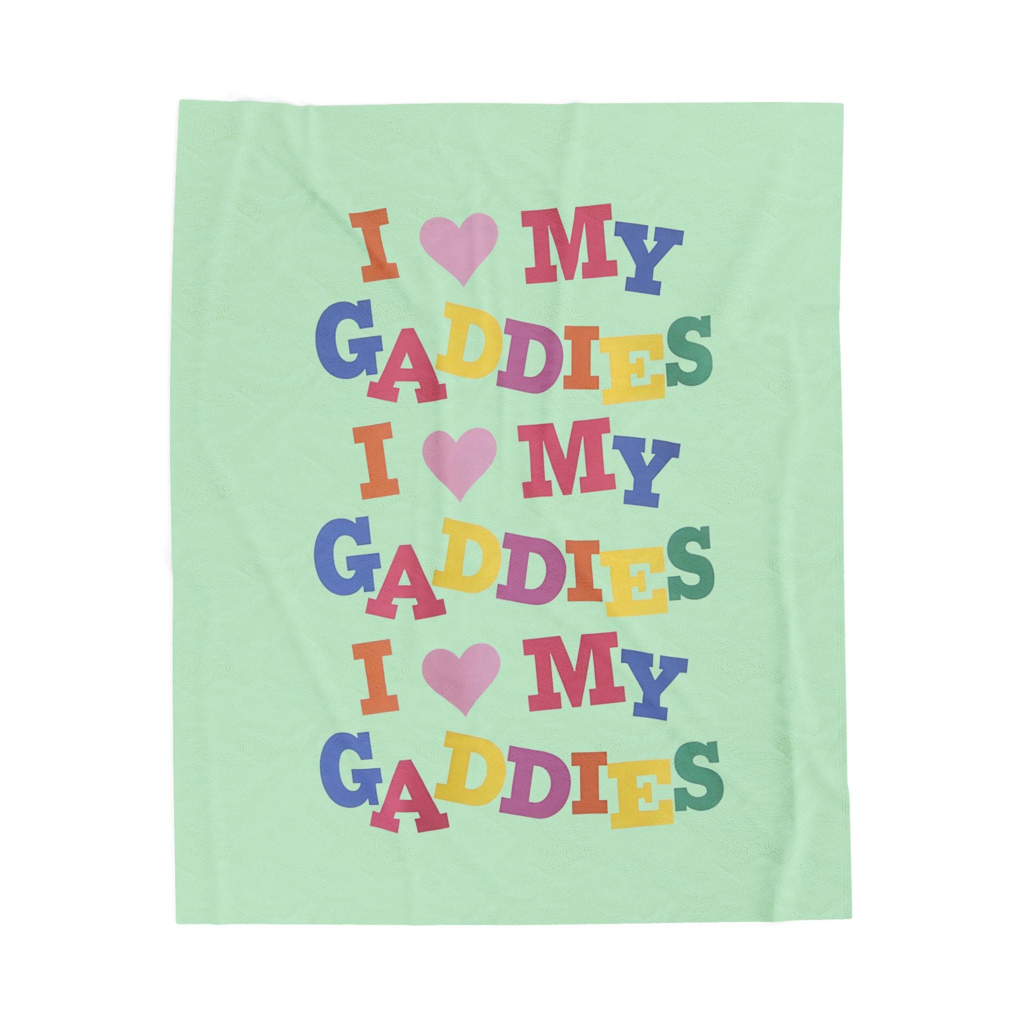 Colorful throw blanket on bed featuring bold rainbow text that says “I Love My Gaddies” – perfect LGBTQ+ gift for chosen family and pride celebrations.

