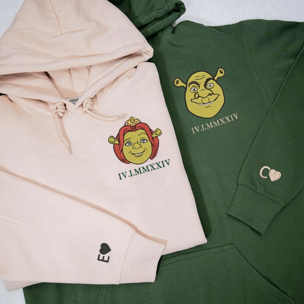 Green and beige Shrek-themed sweatshirts laid out on a white background.