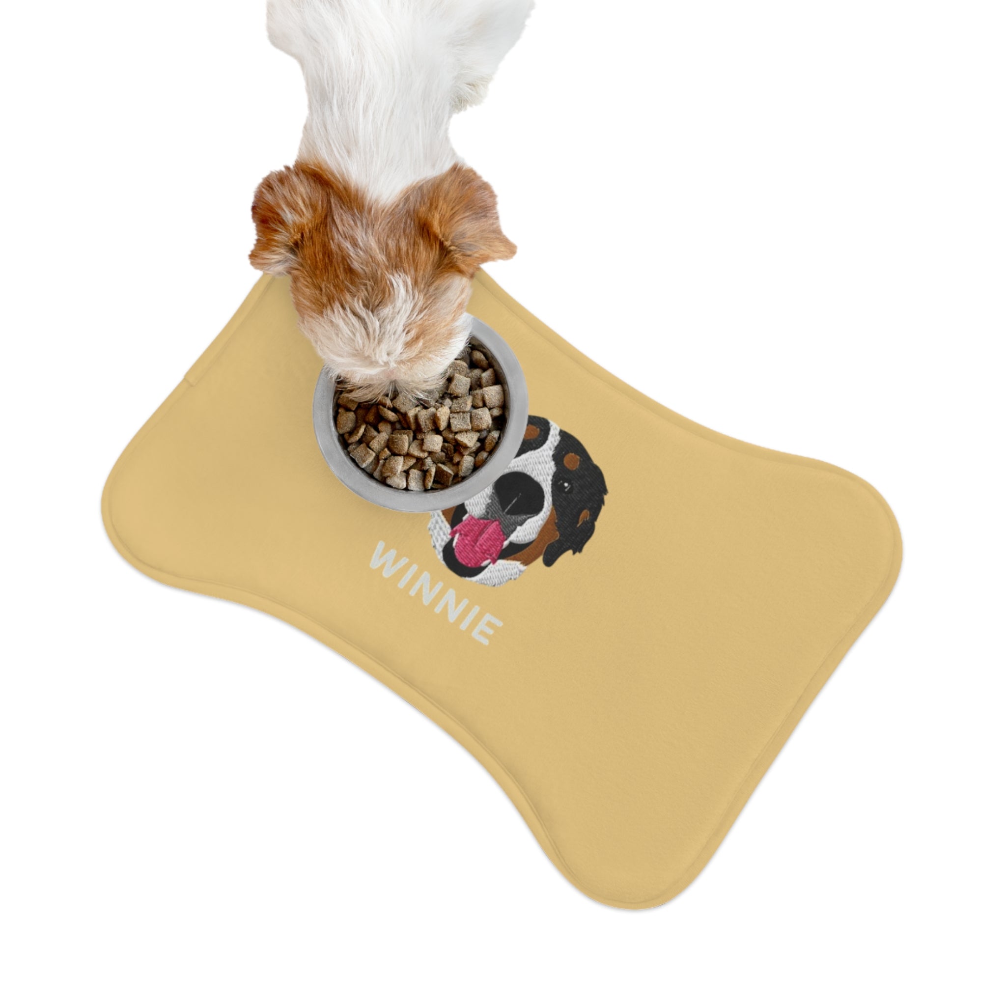 Blue bone-shaped custom feeding mat featuring an embroidered-style portrait of a Bernese Mountain Dog with the name “Winnie” printed underneath.

