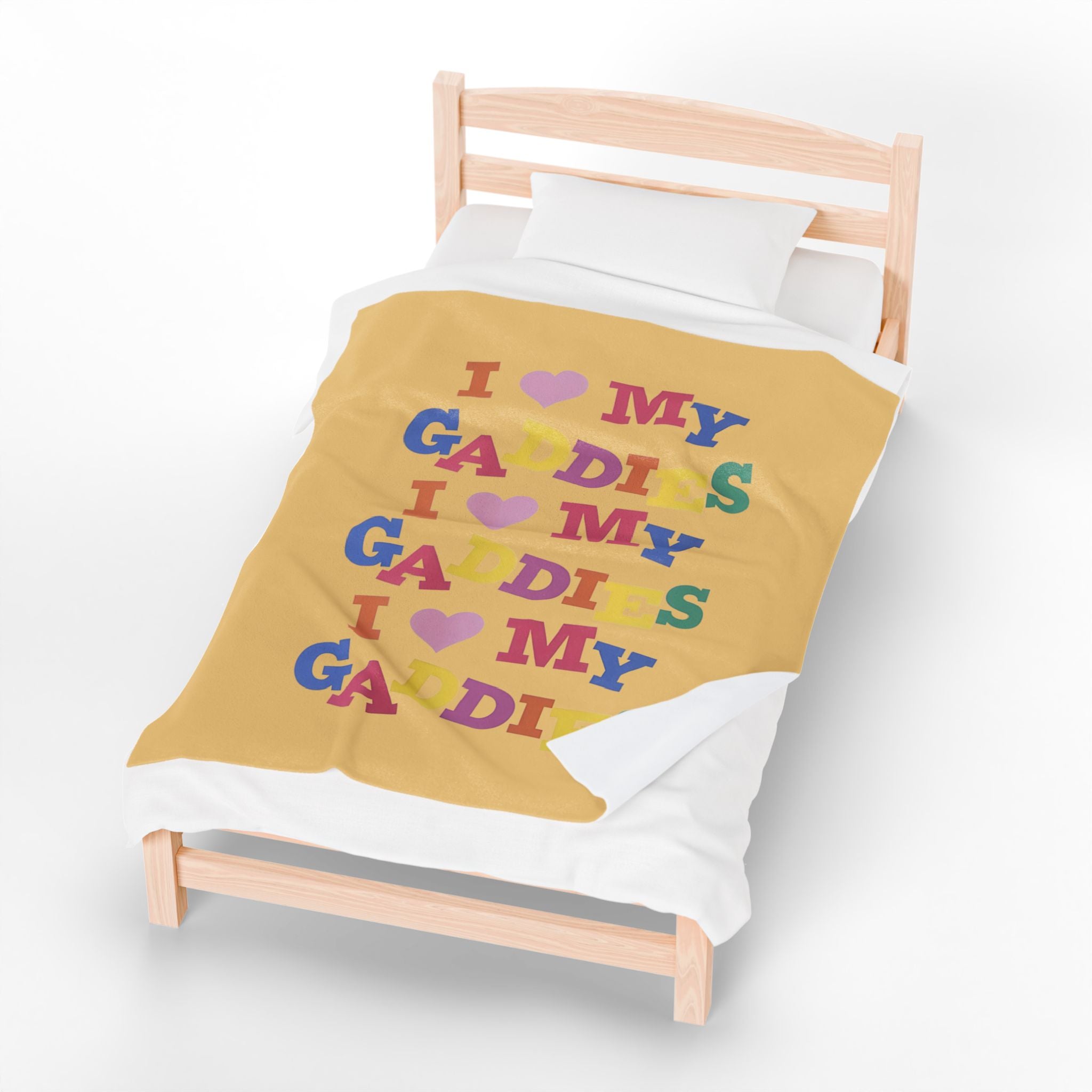 Colorful throw blanket on bed featuring bold rainbow text that says “I Love My Gaddies” – perfect LGBTQ+ gift for chosen family and pride celebrations.

