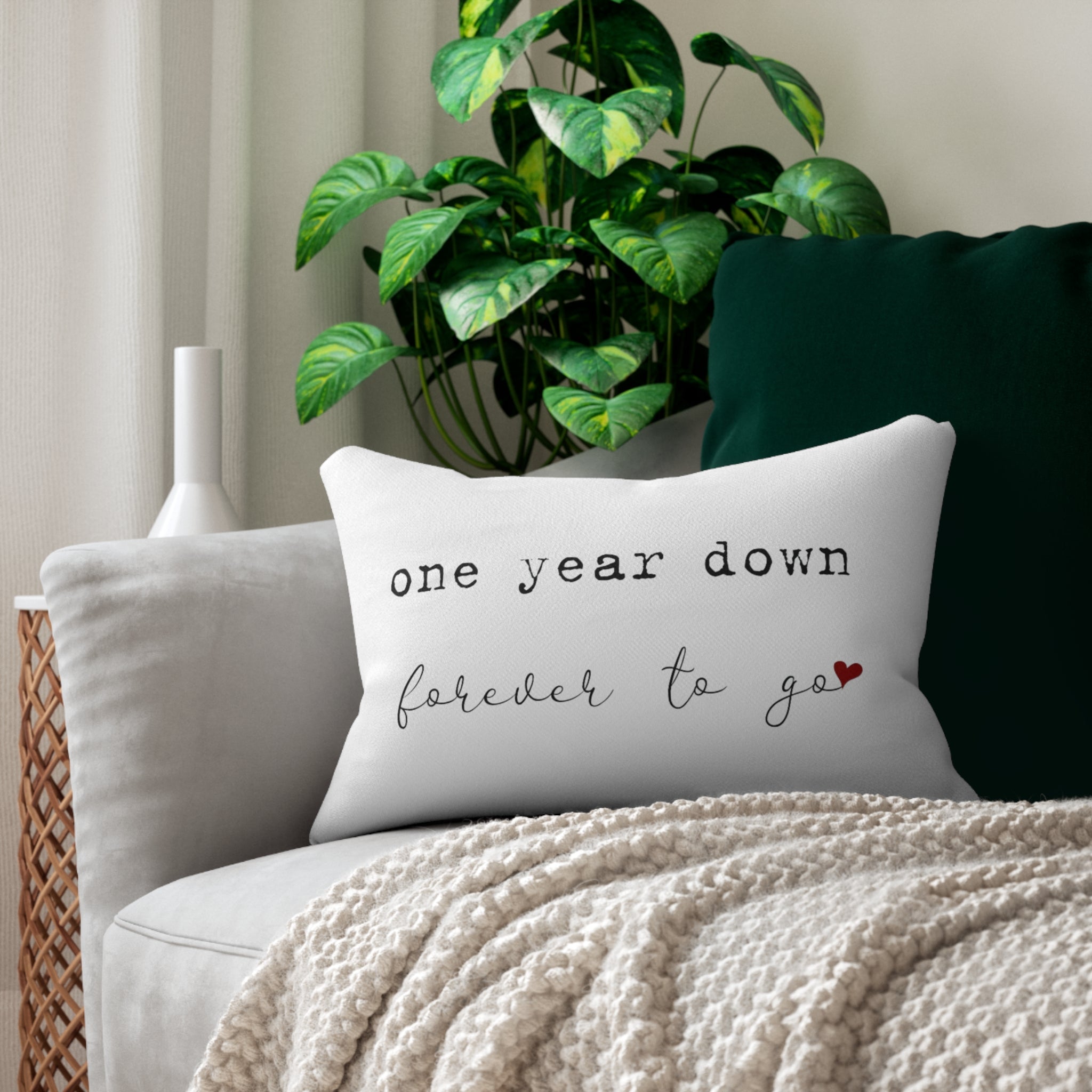 Cozy heart icon pillow on sofa with "One Year Down, Forever to Go" design