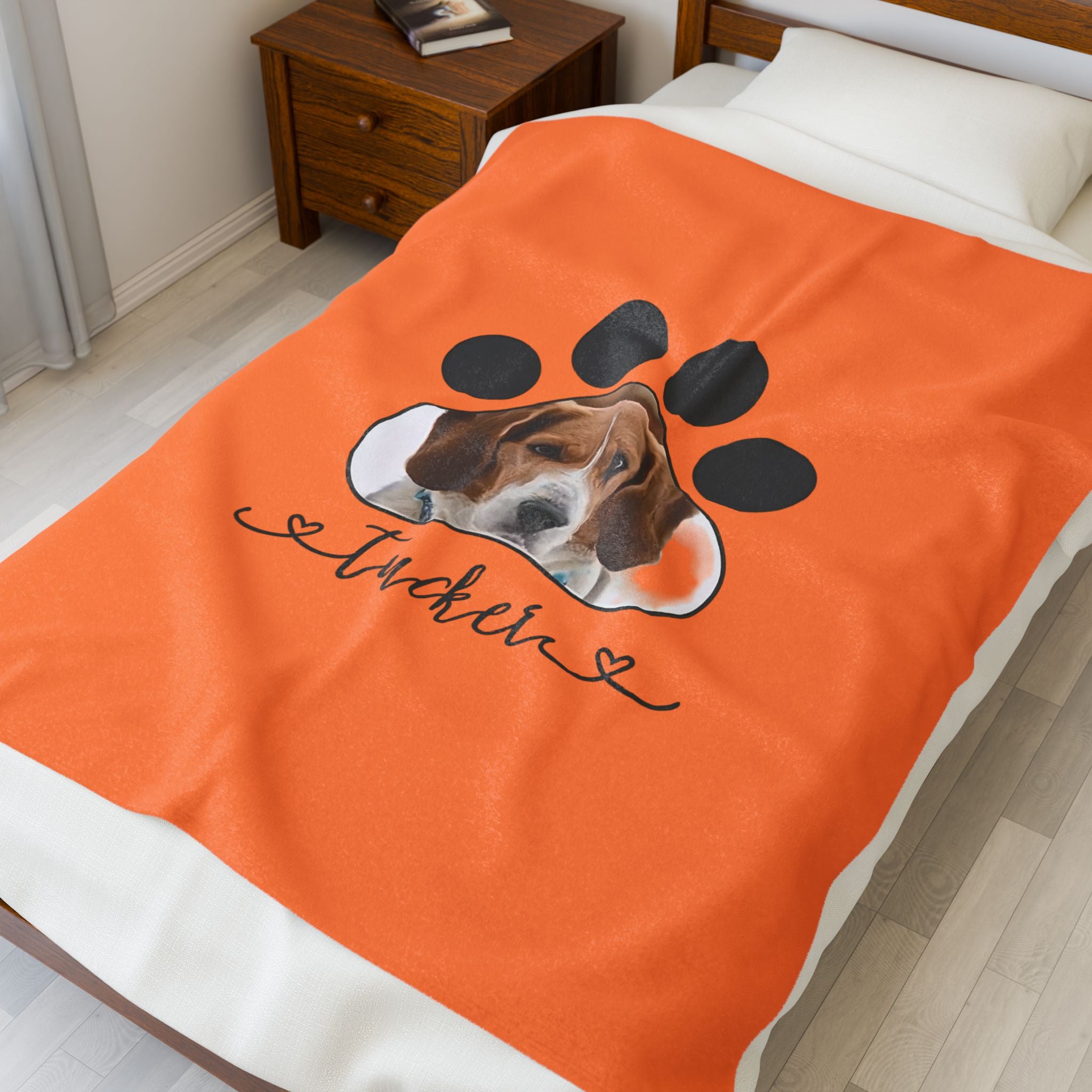Personalized pet blanket with dog photo inside a paw print and custom name printed underneath.

