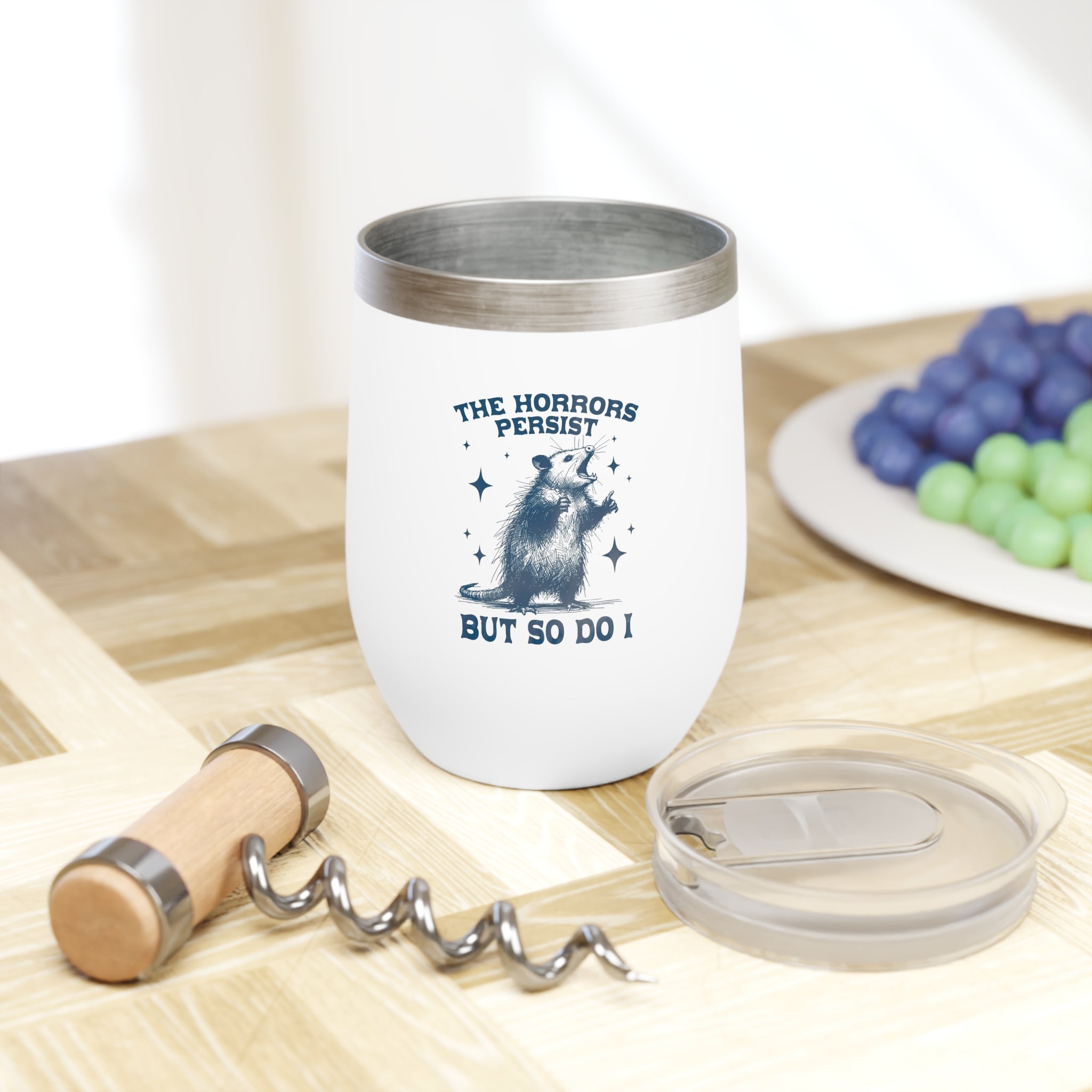 Close-up of stainless steel wine tumbler with motivational text and spill-proof lids