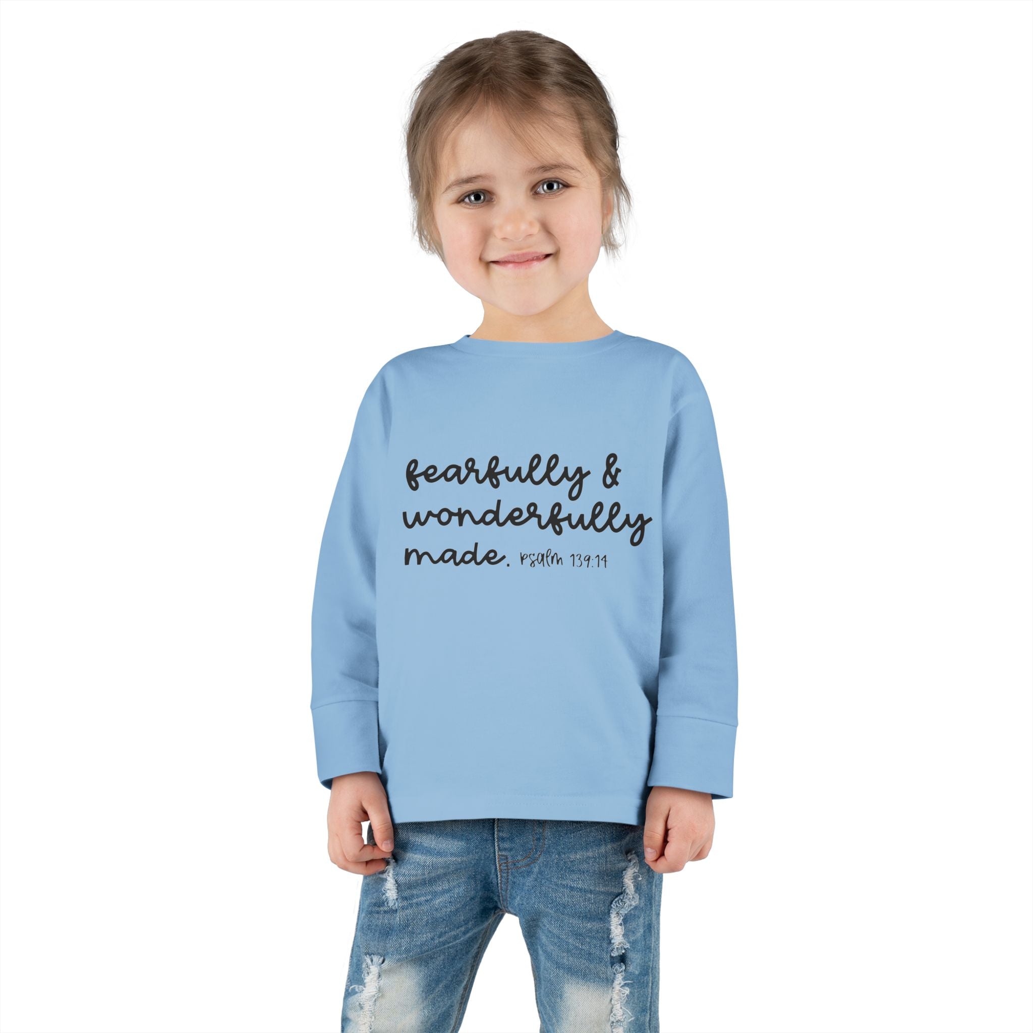 Little girl wearing blue Christian toddler shirt with Bible verse