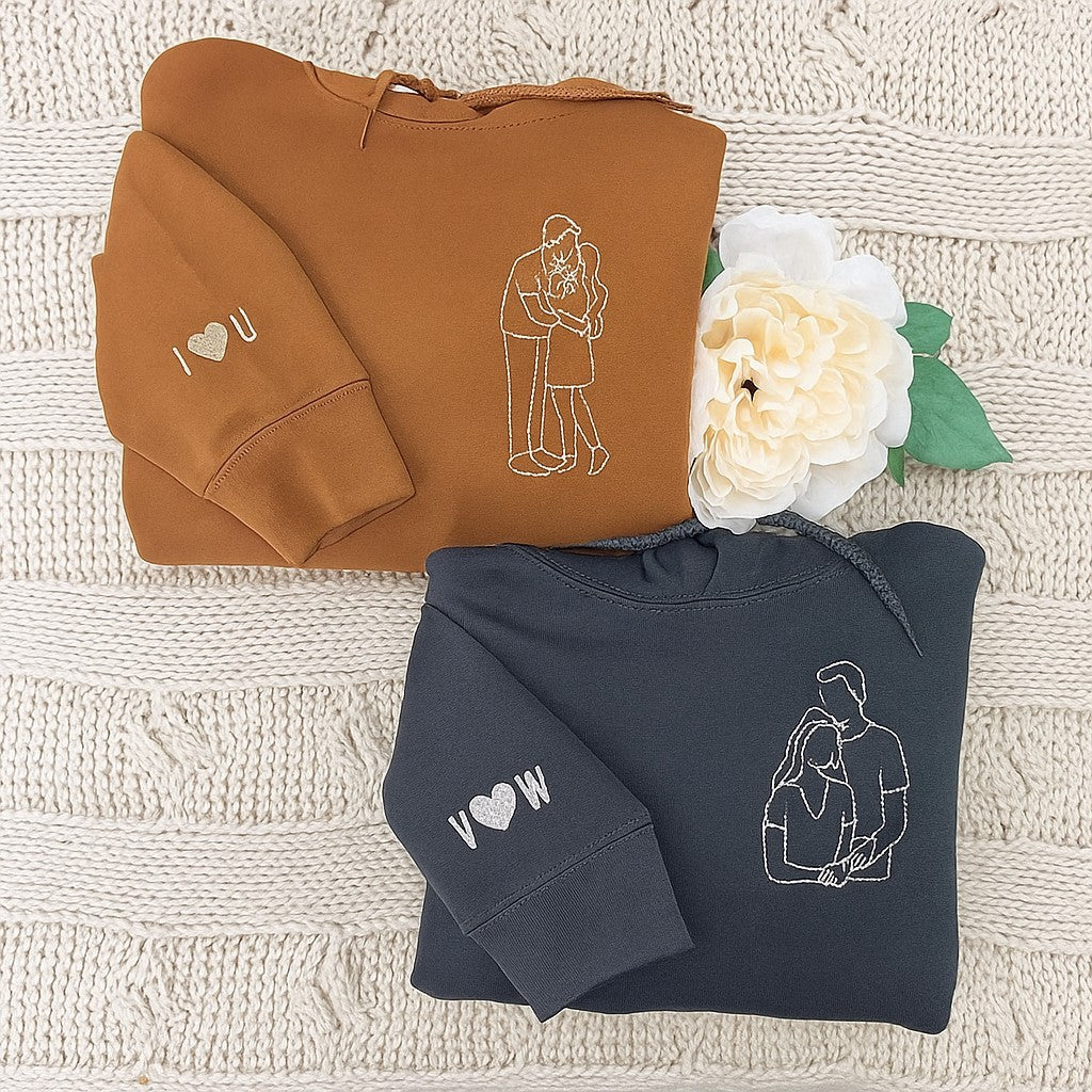 Custom embroidered couple hoodies with minimalist line art portrait design and personalized sleeve initials