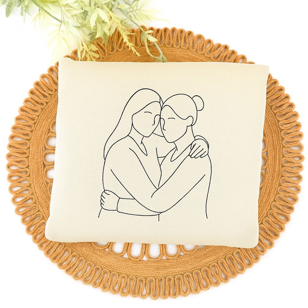 Custom embroidered couple hoodies with minimalist line art portrait design and personalized sleeve initials