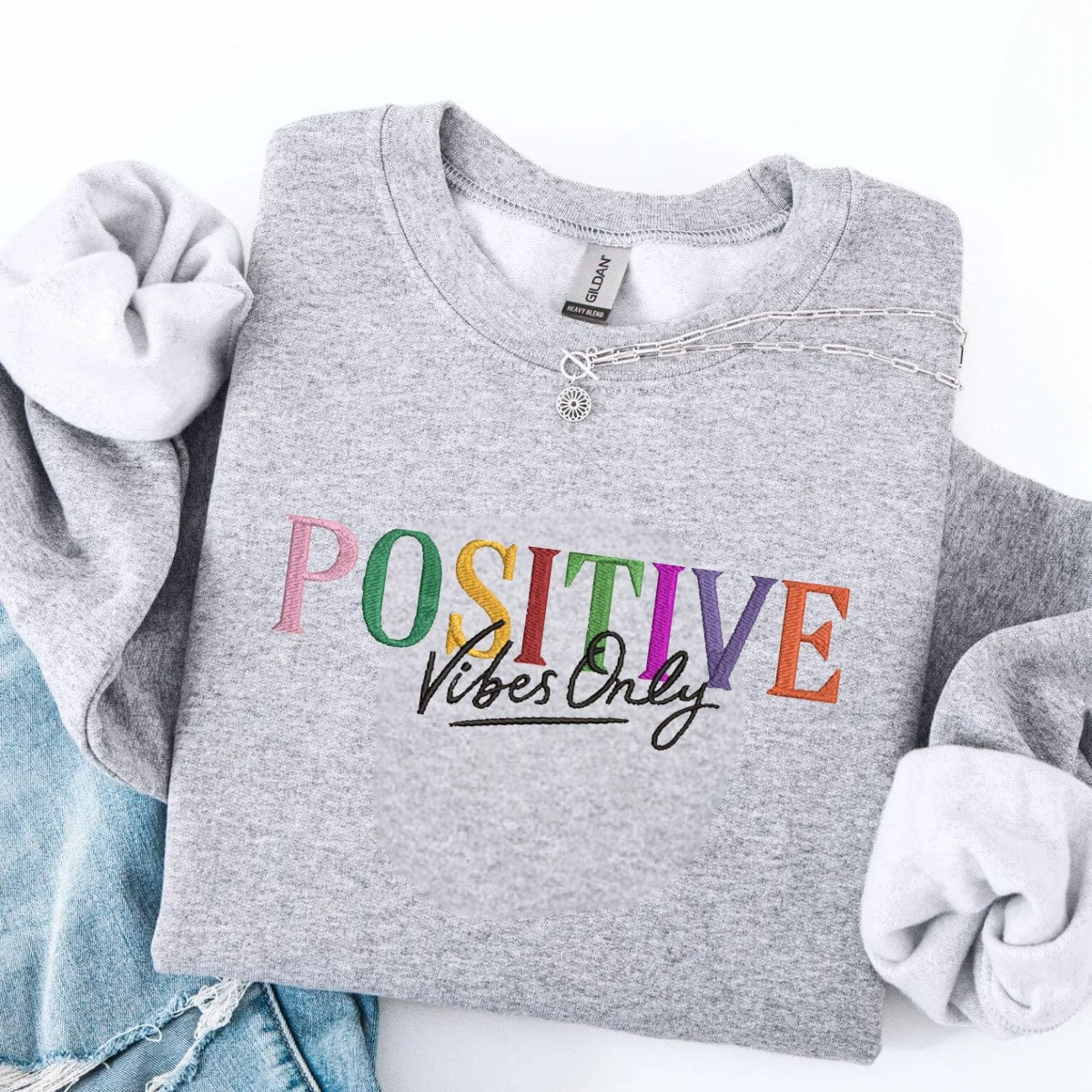 Comfortable and cheerful sweatshirt with a colorful ‘POSITIVE Vibes Only’ design.