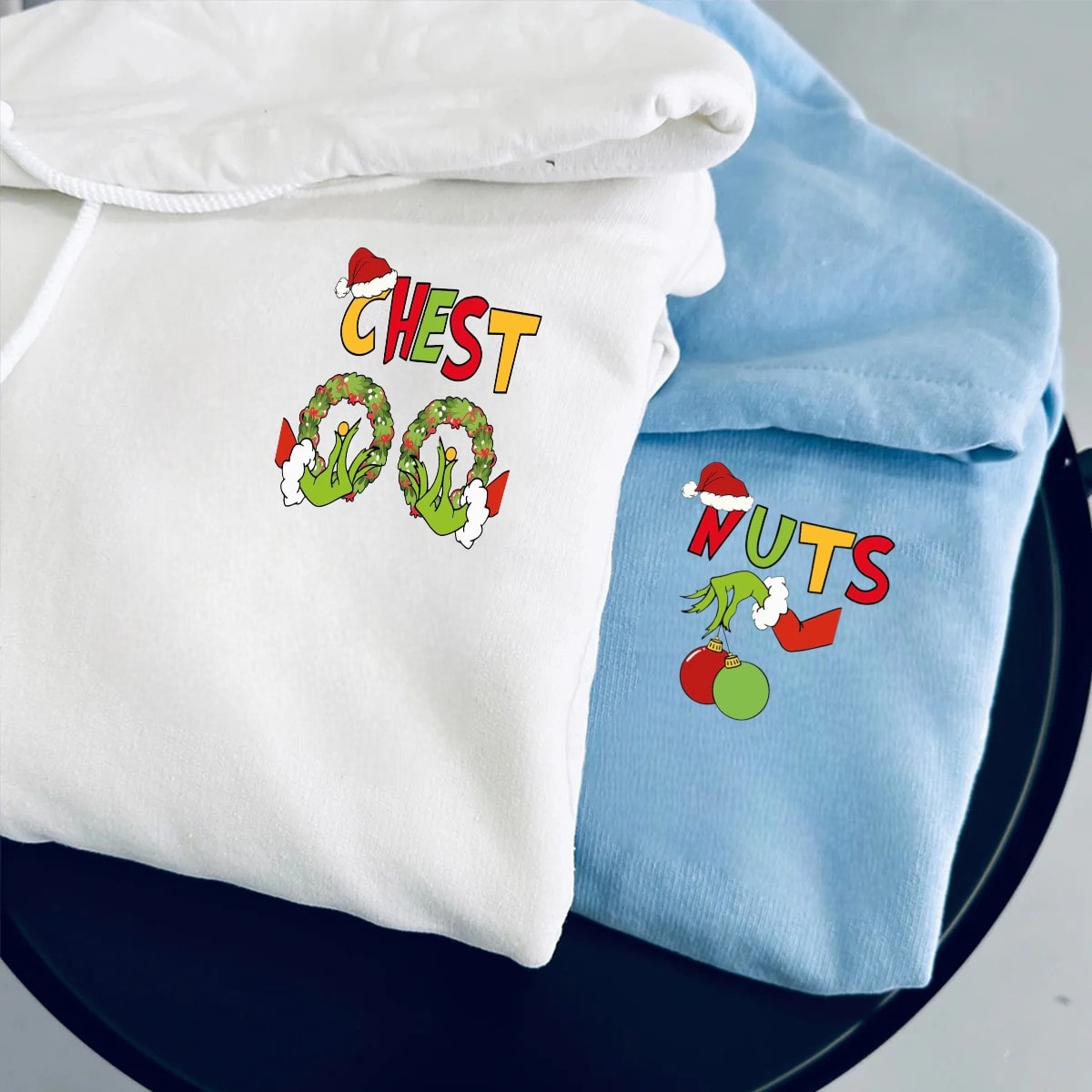 Fun holiday-themed couple sweatshirts featuring wreaths, ornaments, and Santa hats.