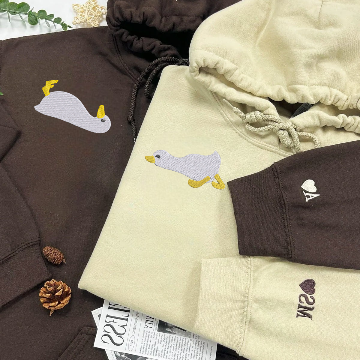 Couple hoodies with custom sleeve initials and playful duck motif








