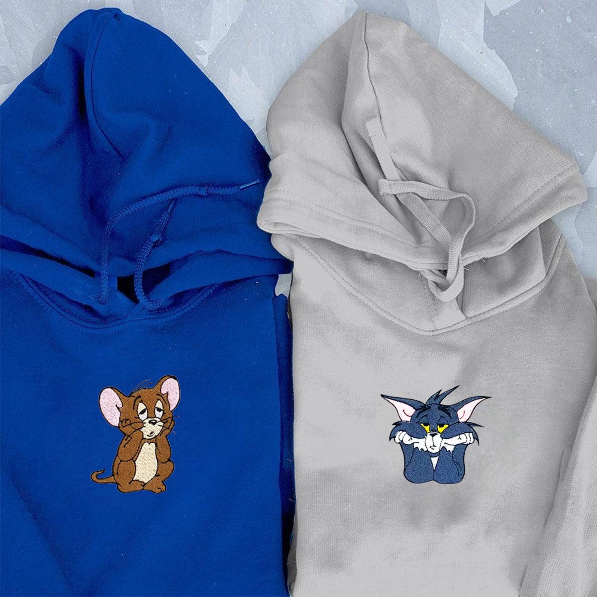 Adorable couple hoodies with playful cartoon embroidery and personalized details.