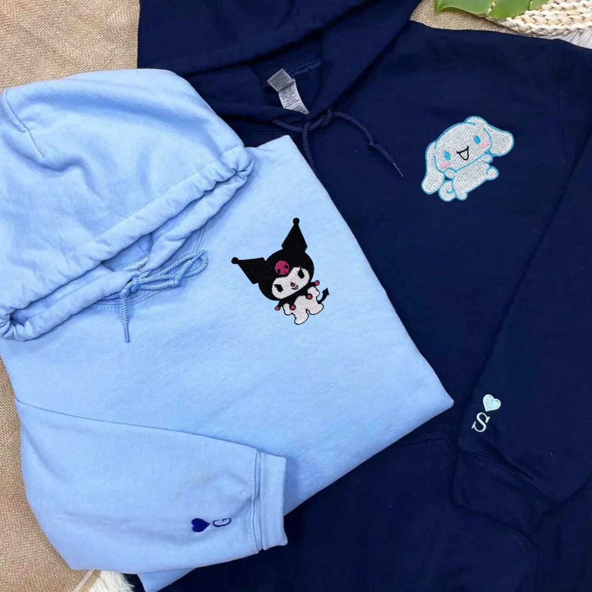 Matching couple hoodies with embroidered cartoon cat and bunny designs.