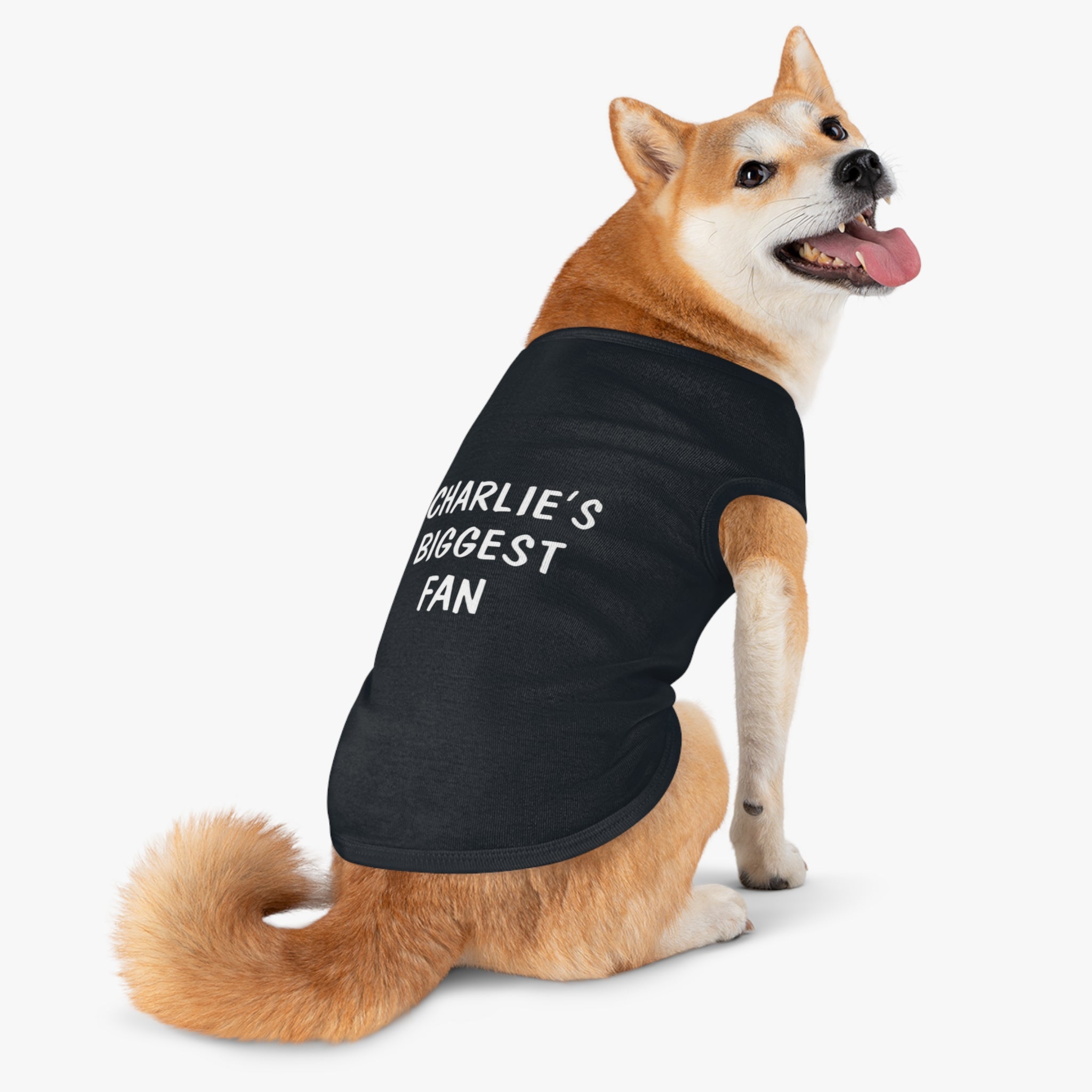 Shiba Inu wearing the "Biggest Fan" customizable dog t-shirt in black.