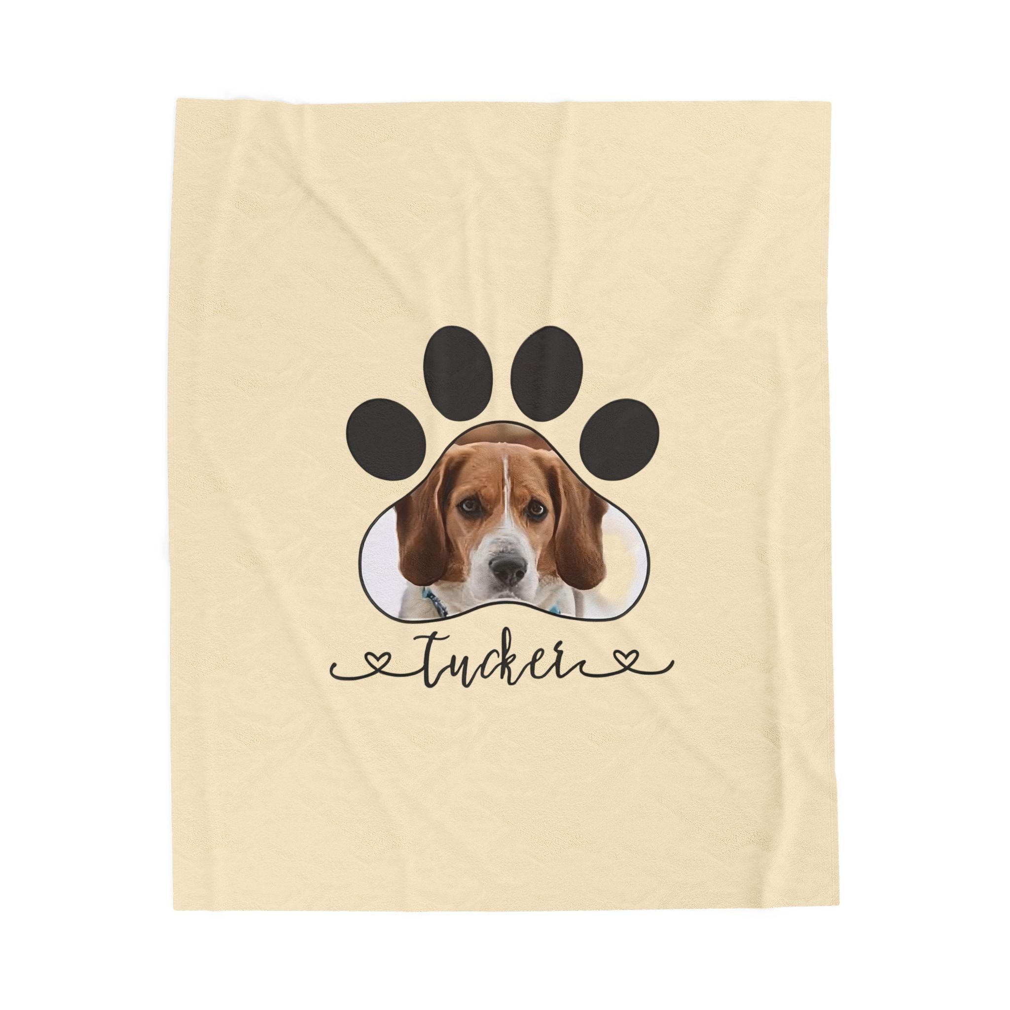 Personalized pet blanket with dog photo inside a paw print and custom name printed underneath.

