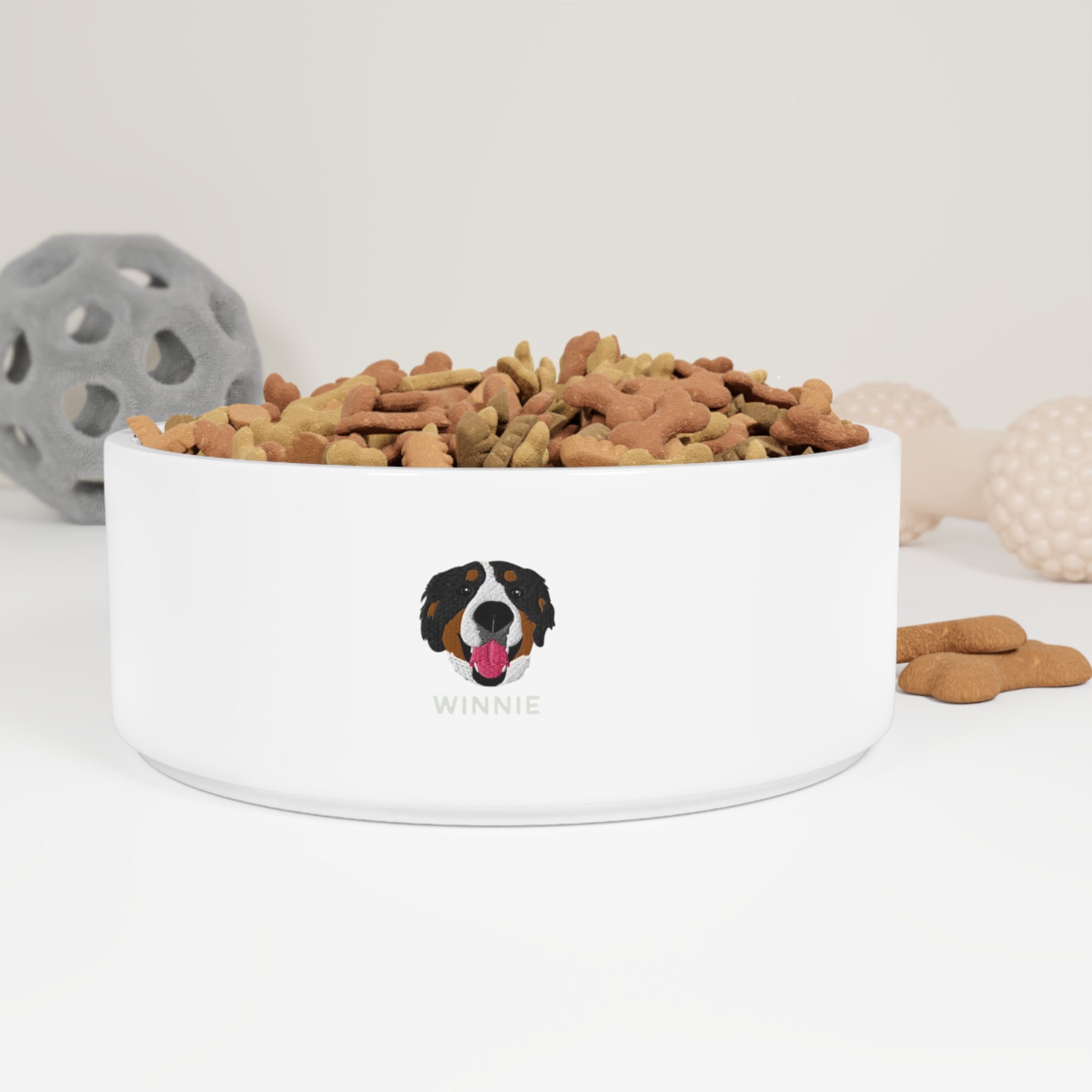 White ceramic custom pet bowl with embroidered-style dog face and the name “Winnie” printed on the front; 16oz capacity with glazed finish.

